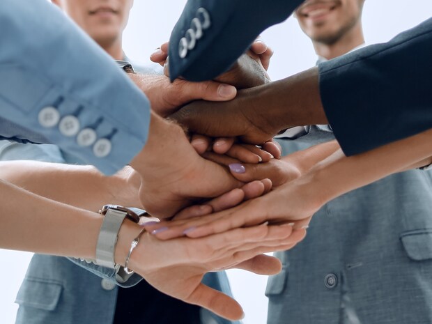 Many hands laid on top of each other